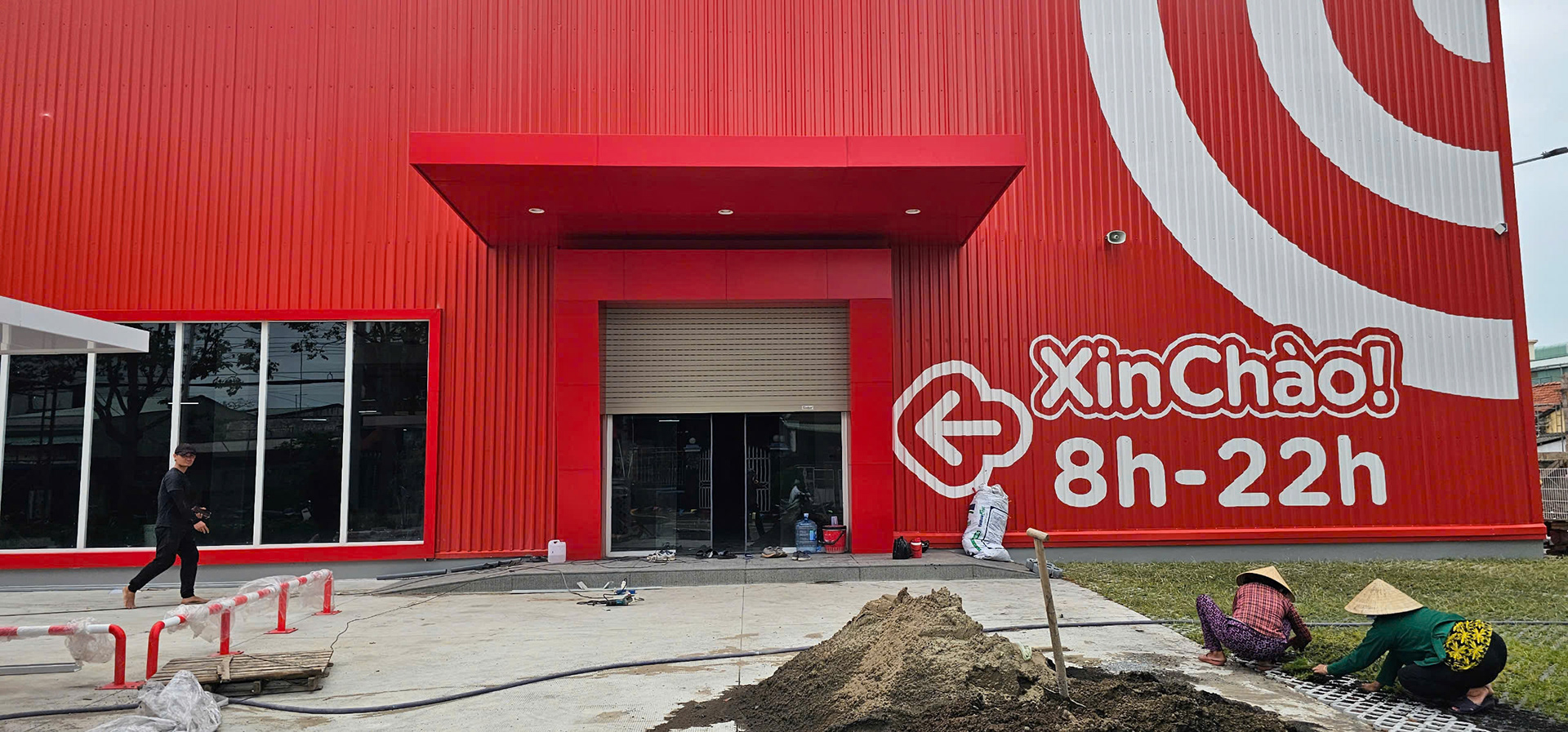 Thi công dán chữ nổi "Xin Chào! 8h - 22h" trên mặt dựng tôn sóng màu đỏ của siêu thị GO!.
